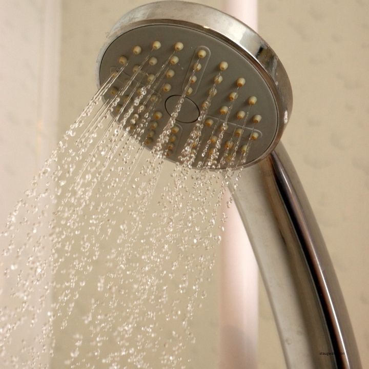 Shower water in a St. Augustine home where hard water can leave mineral buildup and spots